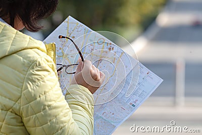 Woman lost hiking, confused looking at map Stock Photo
