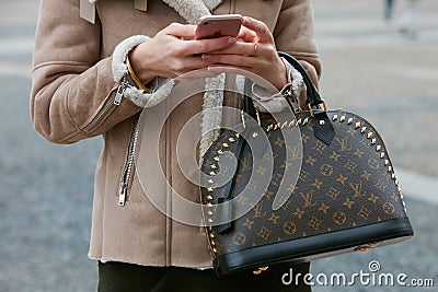 Woman with Louis Vuitton bag and sheep fur coat before Cristiano Burani fashion show, Milan Fashion Week Editorial Stock Photo