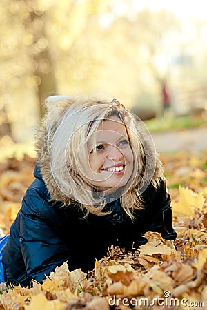 Woman lying in autumn leaves Stock Photo