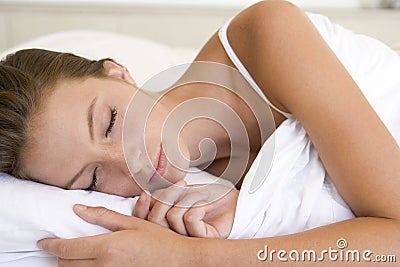 Woman lying in bed sleeping Stock Photo