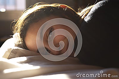 Woman lying in bed and smiling Stock Photo