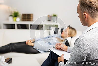 Woman lying on couch at doctors office Stock Photo