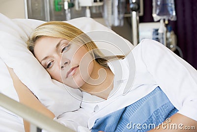 Woman Lying Down In Bed Stock Photo