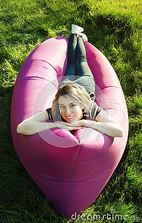 Woman lying in an inflatable sofa Stock Photo