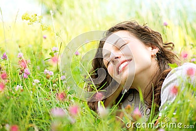 Woman lying in Meadow of Flowers Stock Photo