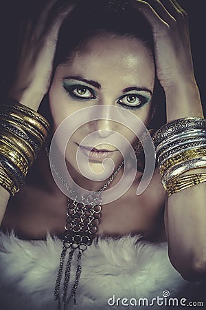 Woman lying and sensual with bracelets of gold and silver, looking Stock Photo