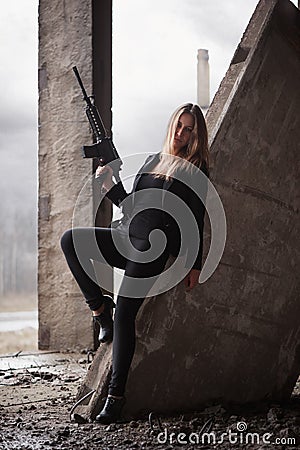 Woman with a machine gun Stock Photo
