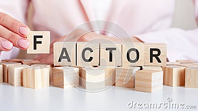 Woman made word factor with wooden blocks Stock Photo