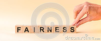 Woman made word fairness with wooden blocks, concept Stock Photo