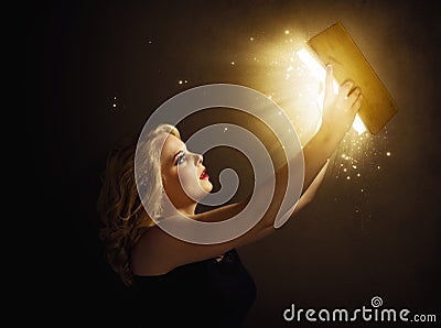 Woman with magic book Stock Photo