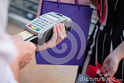 woman make payment with credit card swipe through terminal. customer paying with EDC or swiping machine. buy & sell product or se Stock Photo