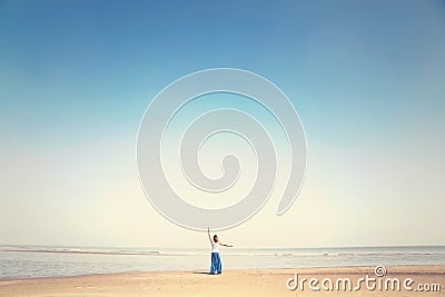 Woman makes meditation exercises facing the sea Stock Photo