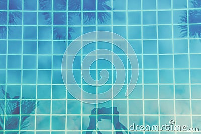 Woman makes pictures of palm trees reflection in the turquoise pool. Multipurpose backdrop Stock Photo