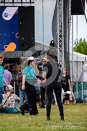 Woman making bubbles to people in the concert at Hangariada aeronautical festival in Iasi Editorial Stock Photo