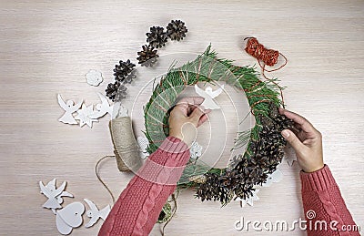 Woman making Christmas wreath and decorating it salt dough stars and angels Stock Photo