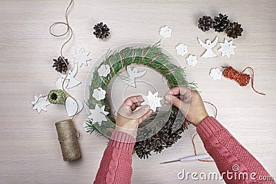 Woman making Christmas wreath and decorating it salt dough stars and angels Stock Photo