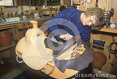 A woman making a custom made saddle Editorial Stock Photo