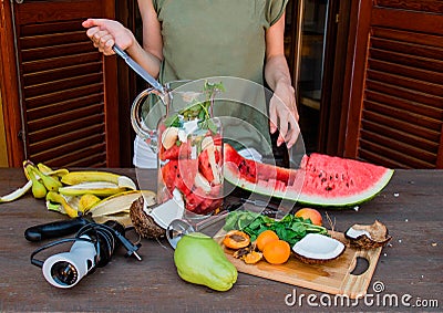 Woman making fruit cocktail Stock Photo