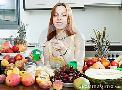 Woman making fruit salad with yoghourt Stock Photo
