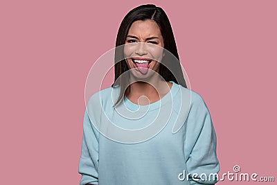 Woman making funny goofy face with tongue sticking out, expressive comedic asian american portrait Stock Photo