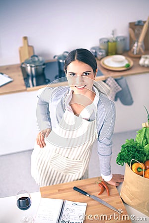 Woman making healthy food standing smiling in kitchen Stock Photo