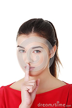 Woman making a keep it quiet gesture Stock Photo