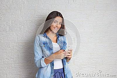 Woman is making an on-line purchase with smart phone. Looking at camera. App, technology, wireless, buying concept Stock Photo