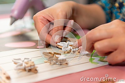 Woman making a little wooden artwork Stock Photo