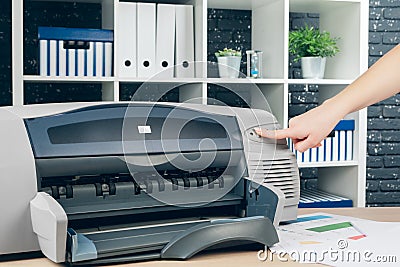 Woman making photocopy using copier in office Stock Photo