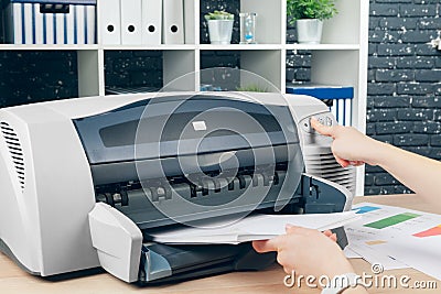 Woman making photocopy using copier in office Stock Photo