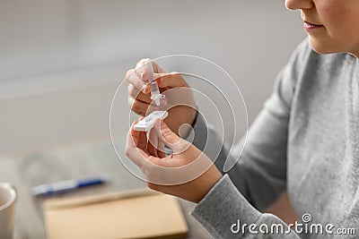 woman making self testing coronavirus test at home Stock Photo