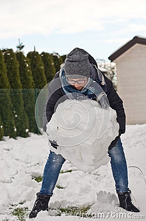 Woman making snowman Stock Photo