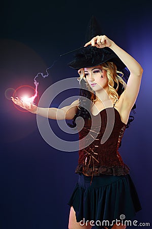 Woman making spell with magic fireball Stock Photo