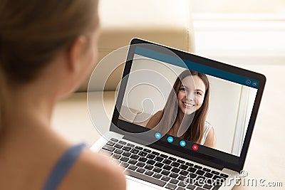 Woman making video call to female friend on laptop. Stock Photo