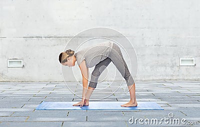 Woman making yoga intense stretch pose on mat Stock Photo