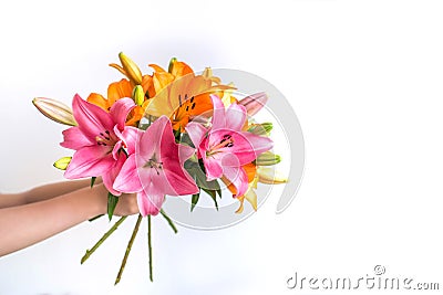 Woman man child hands holding give a bouquet of pink and orange lilies on a white background Stock Photo