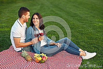 Woman and man clicking with wine glasses Stock Photo