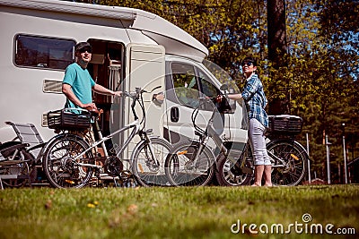 Woman with a man on electric bike resting at the campsite. Stock Photo