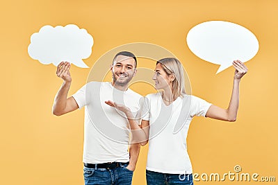 Woman and man holding paper thought bubbles Stock Photo
