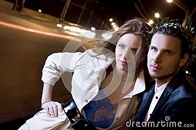 Woman and man on illuminated street at night Stock Photo