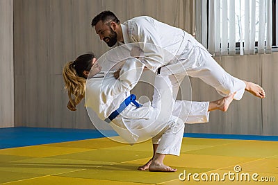 Woman and man judo fighters in sport hall Stock Photo
