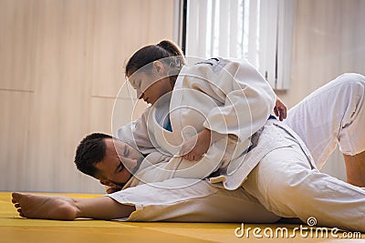 Woman and man judo fighters in sport hall Stock Photo