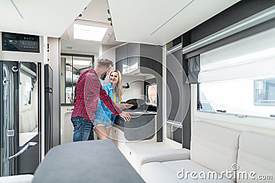 Woman and man testing interior of camper they want to buy or rent Stock Photo