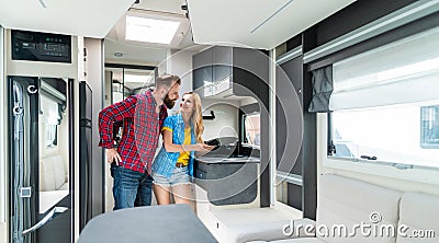 Woman and man testing interior of camper they want to buy or rent Stock Photo