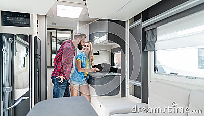 Woman and man testing interior of camper they want to buy or rent Stock Photo