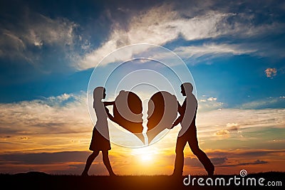 Woman and man with two halves of broken heart going to be joined in one. Love Stock Photo