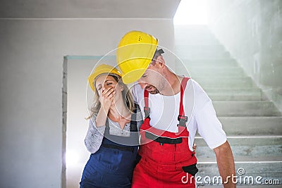 Woman and man workers suffocating at the construction site. Stock Photo