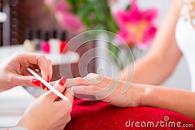 Woman at manicure in nail parlor with file Stock Photo