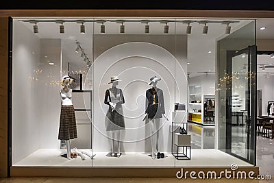 Woman mannequin in fashion shop window Stock Photo