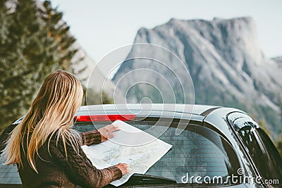 Woman with map planning route traveling by rental car Stock Photo